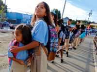 00023955A ma nb AlmadelMar1stDay  A protective 4th grader Kiera Valentin, 9, assures her little sister Alyssa Rodriguez, 5 kindergarten, that everything will be alright on their first day of school at the Alma del Mar's new school on Belleville Avenue in the north end of New Bedford.   PETER PEREIRA/THE STANDARD-TIMES/SCMG : school, education